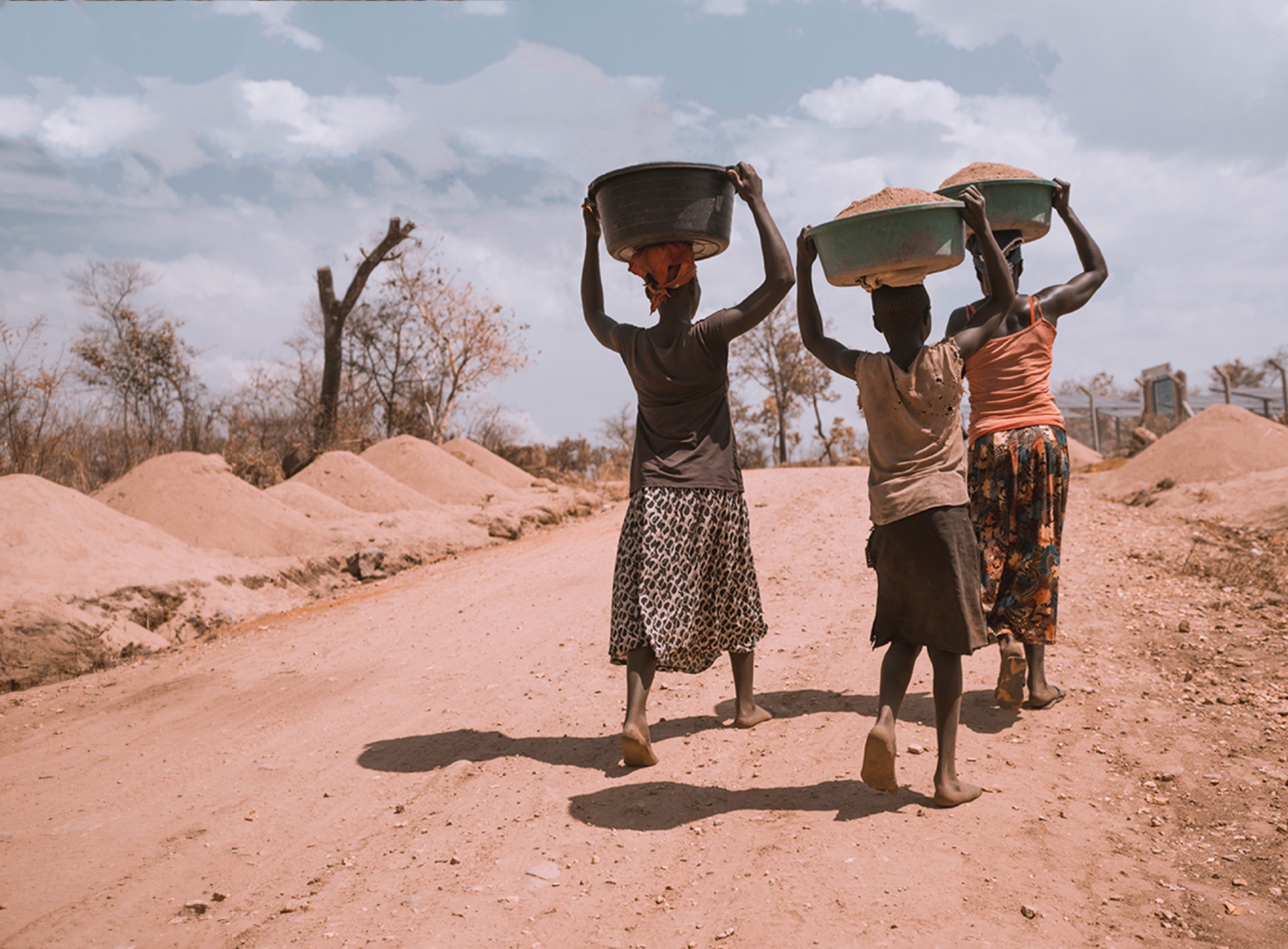 Women carrying supplies in Uganda — community resilience and vocational empowerment in Serere